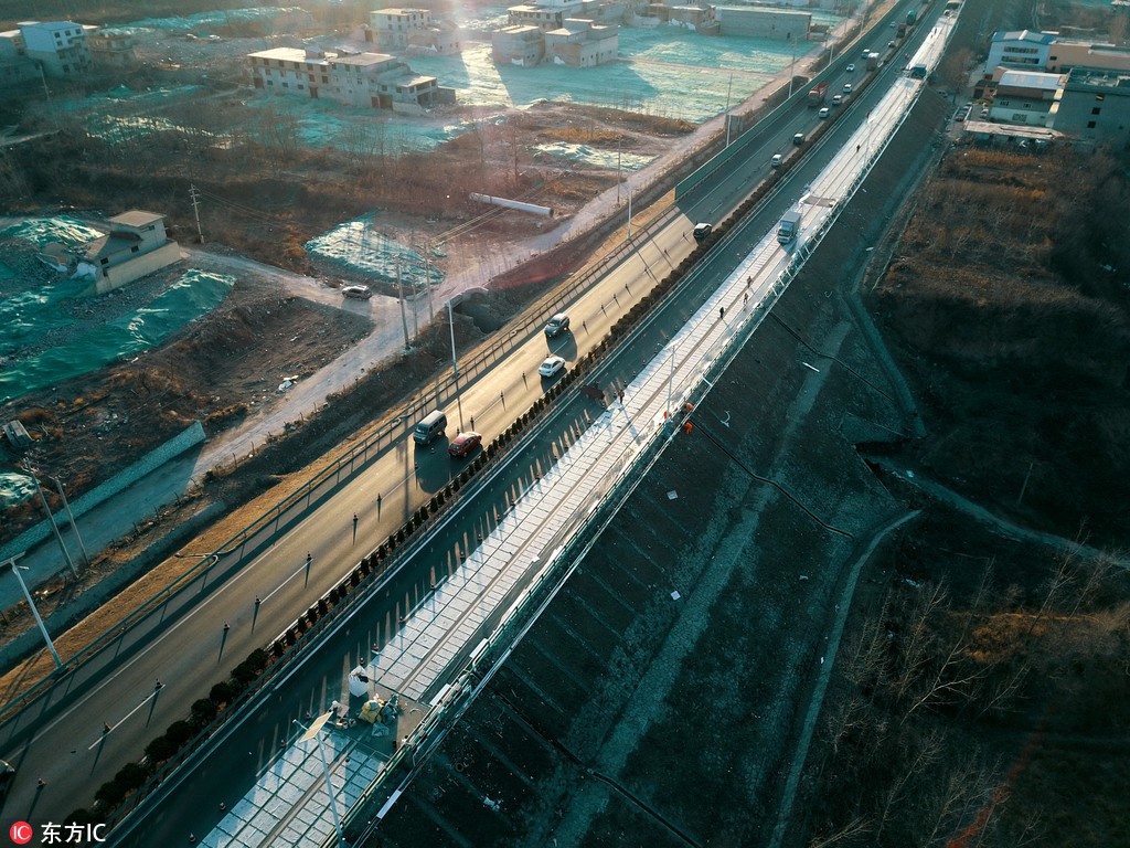 China’s solar highway (right) alongside regular highway
