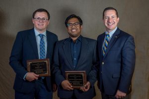 Justin Cyr, left, and Megat Usamah Megat Johari, middle, accept their award for HSIS Excellence in Highway Safety Data Award Competition, with ITE President Michael Sanderson