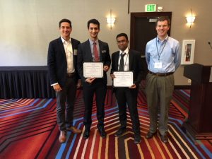 Authors Bijan Vafaei, center left, and Pranamesh Chakraborty, center right, pose with John Brady, left, representing award sponsor Cintra, and Nick Wood, right, chair of student awards and scholarships for the conference. (Photo courtesy of Case Emoto, co-chair, TRB Managed Lane Committee)