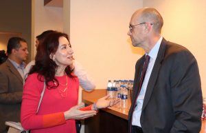 InTrans Associate Scientist Basak Aldemir Bektas talks with Iowa DOT Director Mark Lowe at the celebration.