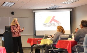 InTrans Director Shauna Hallmark, center, has a discussion with ISU President Wendy Wintersteen after a tour of the institute.