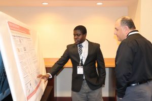 ISU PhD student Kofi Oppong discusses research into over-height truck collisions to bridge girders during the poster presentation session.