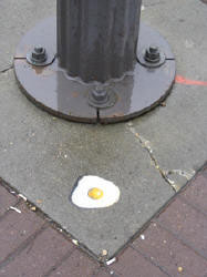 Egg frying on sidewalk