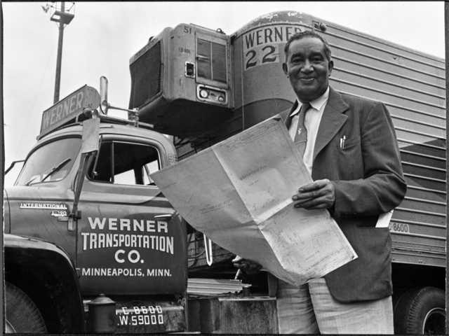 Frederick McKinley Jones standing next to truck outfitted with a mobile refrigeration unit, circa 1950