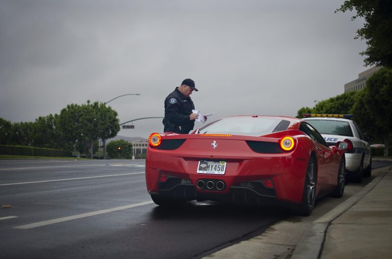 Driver in a red car gets a ticket