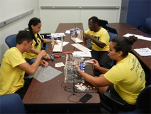 High school students at FIU’s transportation camp design and build a balsa-wood bridge